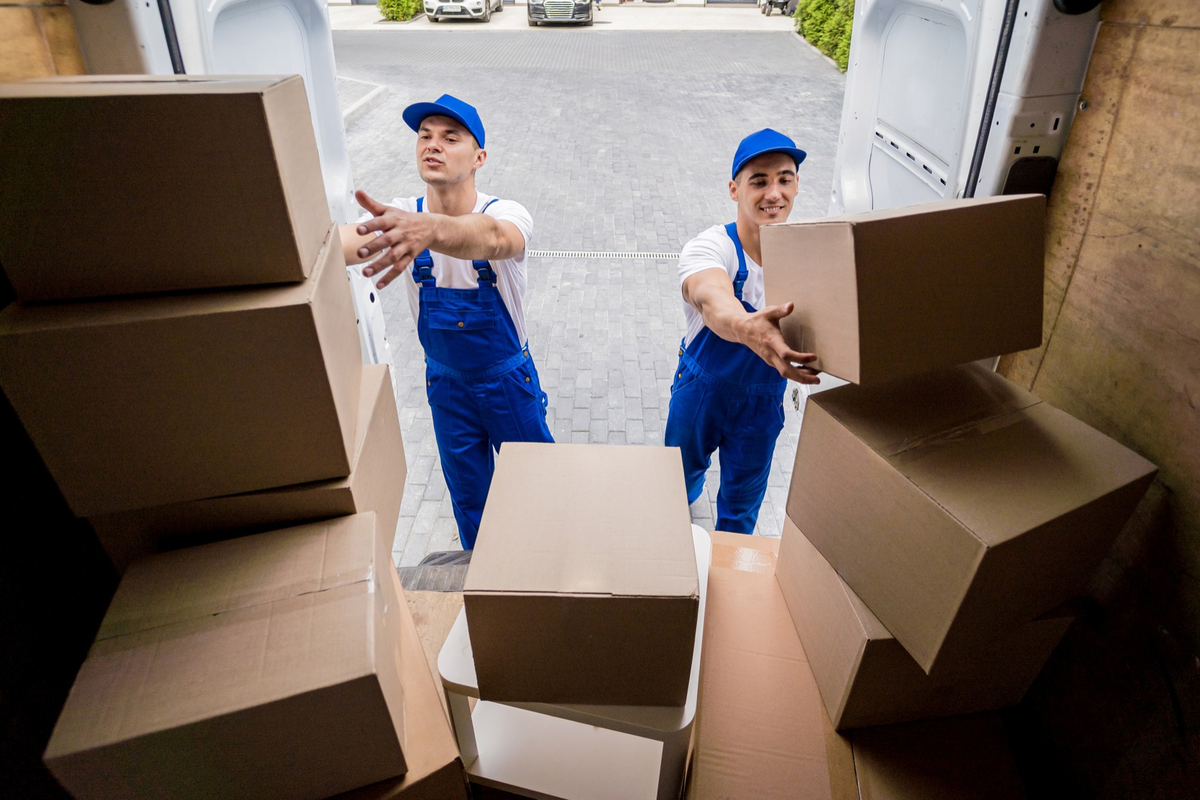 Movers stacking packed boxes inside delivery truck – Moving Pro Dallas