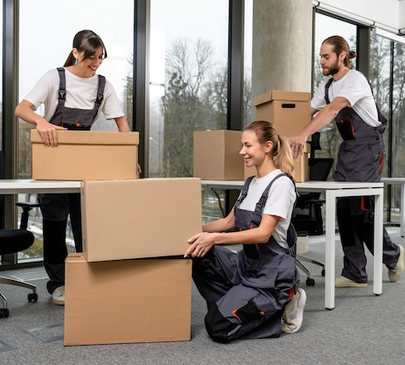 Office moving team packing and organizing boxes at workspace – Moving Pro Dallas